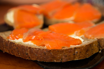 Naklejka na ściany i meble Fresh salmon sandwich with salted salmon and butter and dark bread