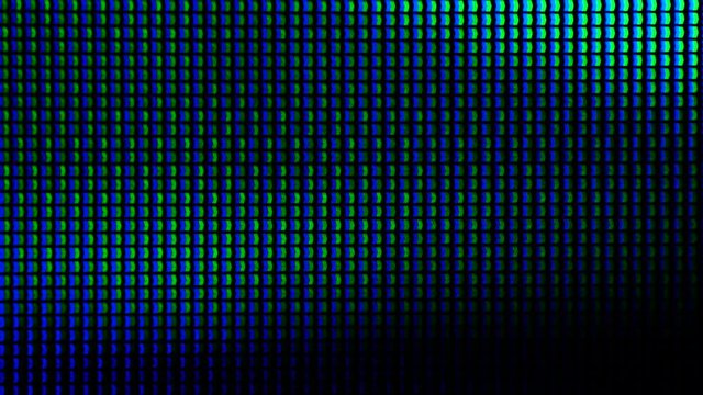 Macro shot of a computer display or TV screen. Multi-colored pixels as trace elements creating an image on an LED or LCD screen.