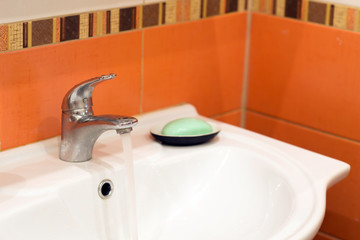 modern bathroom sink, water flowing from tap