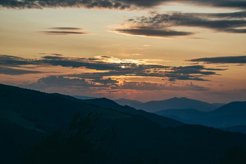 Obraz premium Beautiful Carpathians, mountains in clouds, waterfall, close-up, the sunsets beautifully over the mountains
