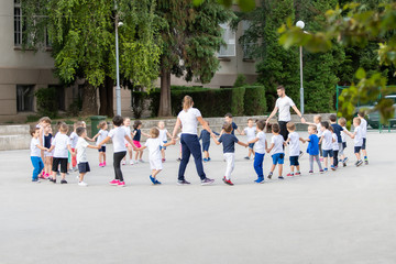 Group of children warming up and preparing for the main part of lesson.  Sport school