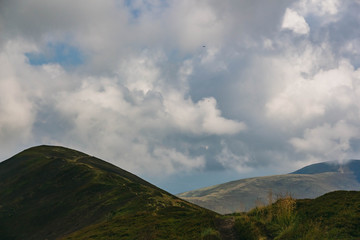 Beautiful Carpathians, mountains in clouds, waterfall, close-up, the sunsets beautifully over the mountains