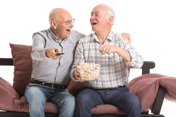 Portrait of elderly men watching TV on white background