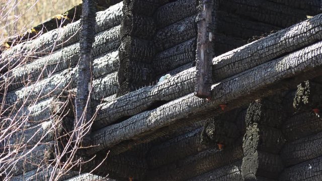 burnt wooden log house, charred wood
