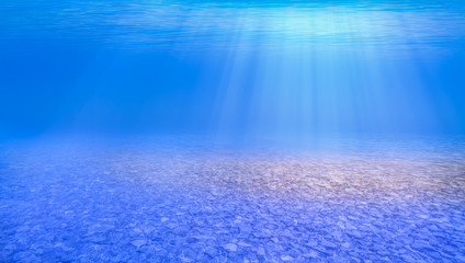 Obraz premium Blue sea or ocean water surface and underwater with sunny day on the foreground pebbles