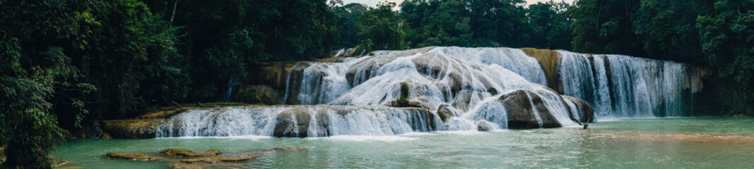 Famous waterfall in Mexico. Beautiful green color. Agua Azul. Sunny weather. Pictures on the screen saver Panorama
