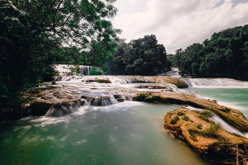 Famous waterfall in Mexico. Beautiful green color. Agua Azul. Sunny weather. Pictures on the screen saver