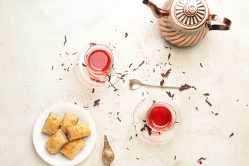Tasty Turkish tea with sweets on white background