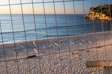 Home sign drawn into the  sand at the closed Bronte Beach, Sydney Australia