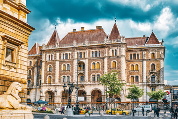 Fototapeta na wymiar BUDAPEST, HUNGARY-MAY 02,2016: Dreschler Palace-gorgeous building in front of the Opera in Budapest. Street view with people.