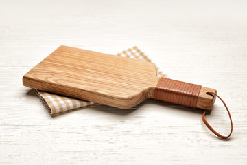 Fototapeta premium Cutting board on white wooden background