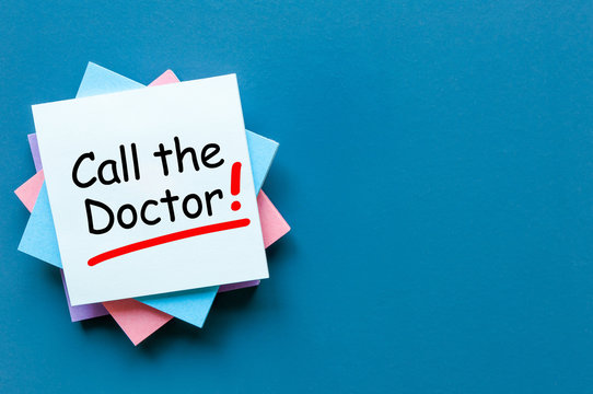 Call the Doctor - note pinned at corkboard. Concept of healthy life 911