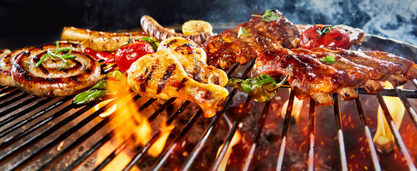 Panorama banner of assorted meat grilling on a BBQ - obrazy, fototapety, plakaty