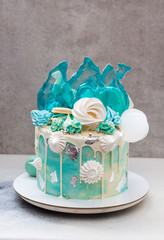 Modern Frozen theme cake decorated with blue caramel, white chocolate, fondant snowflakes,...