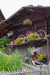 Fototapeta na wymiar Traditional wooden house with flowers in Switzerland