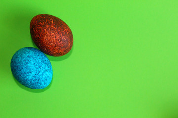Lots of colored eggs on a green background.