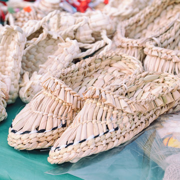 Souvenir bast shoes woven from bast. Old traditional Russian shoes