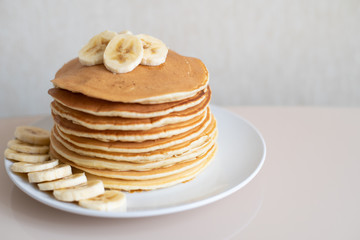 Healthy breakfast,homemade classic american pancakes with fresh banana slices. Food photography.