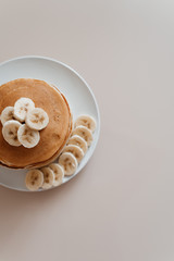 Healthy breakfast,homemade classic american pancakes with fresh banana slices. Food photography.