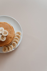 Healthy breakfast,homemade classic american pancakes with fresh banana slices. Food photography.