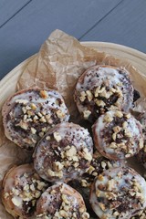 Freshly baked cinnabon buns with cream sauce on baking paper