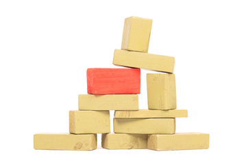 Vintage green building blocks isolated on white, one standing out