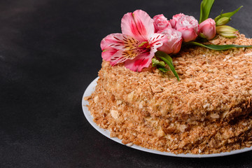 Fresh delicious cake napoleon with cream on a dark background