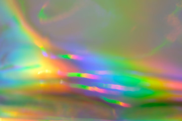 abstract holographic iridescent foil texture background with rainbow colored spots
