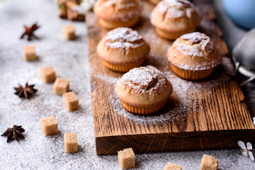Fresh baked cupcakes of rice flour with banana and vanilla with a mug of hot chocolate