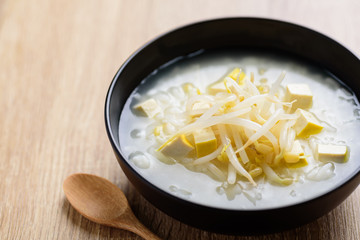 Rice soup with tofu and mung bean sprout in a bowl, Asian food	