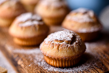 Fresh baked cupcakes of rice flour with banana and vanilla with a mug of hot chocolate