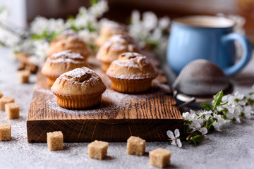 Fresh baked cupcakes of rice flour with banana and vanilla with a mug of hot chocolate