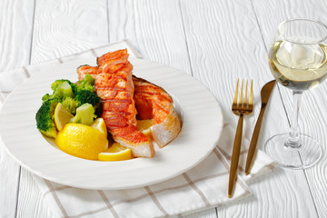 Atlantic salmon with broccoli, lemon on a plate