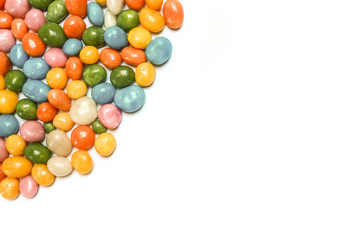 assorted bean candies placed in the corner of white background