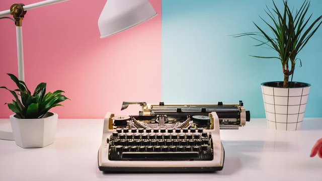 stop motion animation, retro typewriter prints flowers, female hand picks up a bouquet
