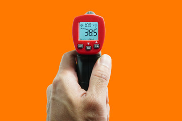 Medical electronic thermometer with high body temperature indicators,COVID-19,an orange background