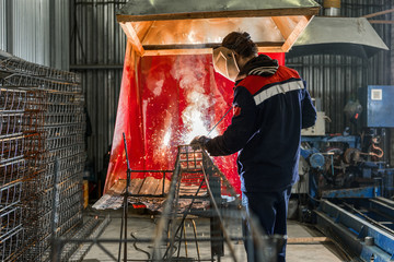 The welder welds steel reinforcement.
