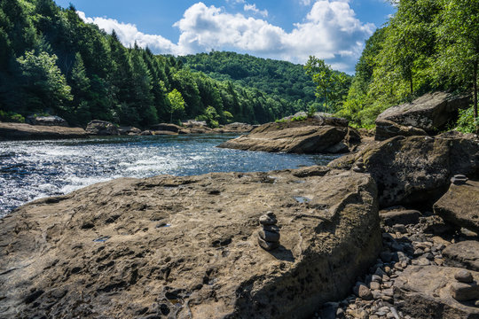 This image of the Gauley River in West Virginia, was captured while standing on a large boulder on the shoreline. A cairn is seen in the foreground.