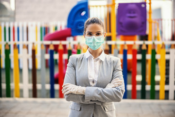 Young woman with protective mask and gloves standing in front of camera, prevent infection of...