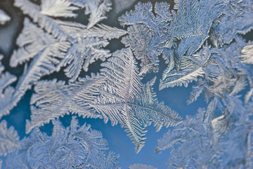 Frosty patterns on the glass. Blue frost texture drawing