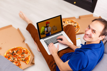 Man using laptop for online food order during quarantine, closeup. Delivery service