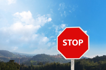 Stop sign on the blue sky.Stop warning traffic sign on a road