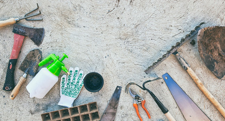 A lot of used and dirty garden tools on the concrete floor outdoor