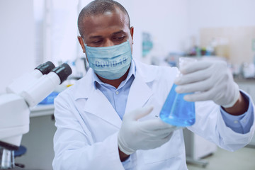 Professional lab worker wearing a medical mask