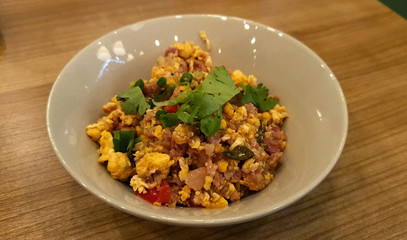Northern Thai style Stir Fried Sour Pork with Egg serving on small bowl on timber table