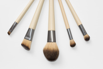 Collection of brown makeup brushes