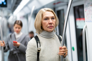 Fototapeta na wymiar Mature woman in subway car