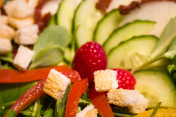 Fresh lettuce salad with raspberry and croutons. close up.