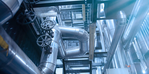 Equipment, cables and piping as found inside of a modern industrial power plant