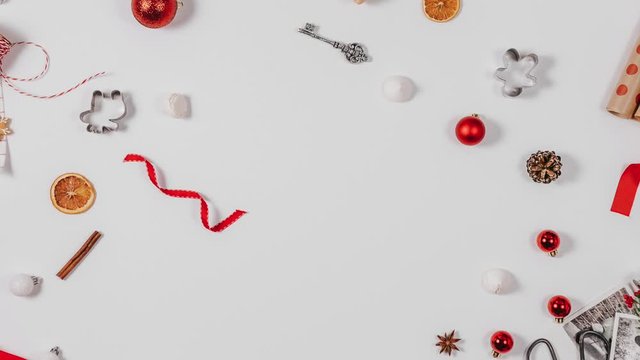 Stop motion animation, different Christmas decorations gather in the middle of the frame in the form of a Christmas tree, in the middle of the tree there is a place for text 